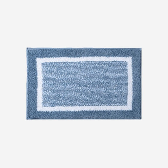 Sininen kylpyhuoneen matto reunuksella
