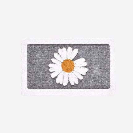 Imukykyinen ovimatto päivänkakkara kuviolla